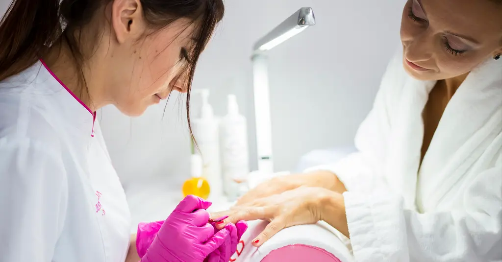 Esthéticienne en micro-entreprise, réalisant un soin à domicile